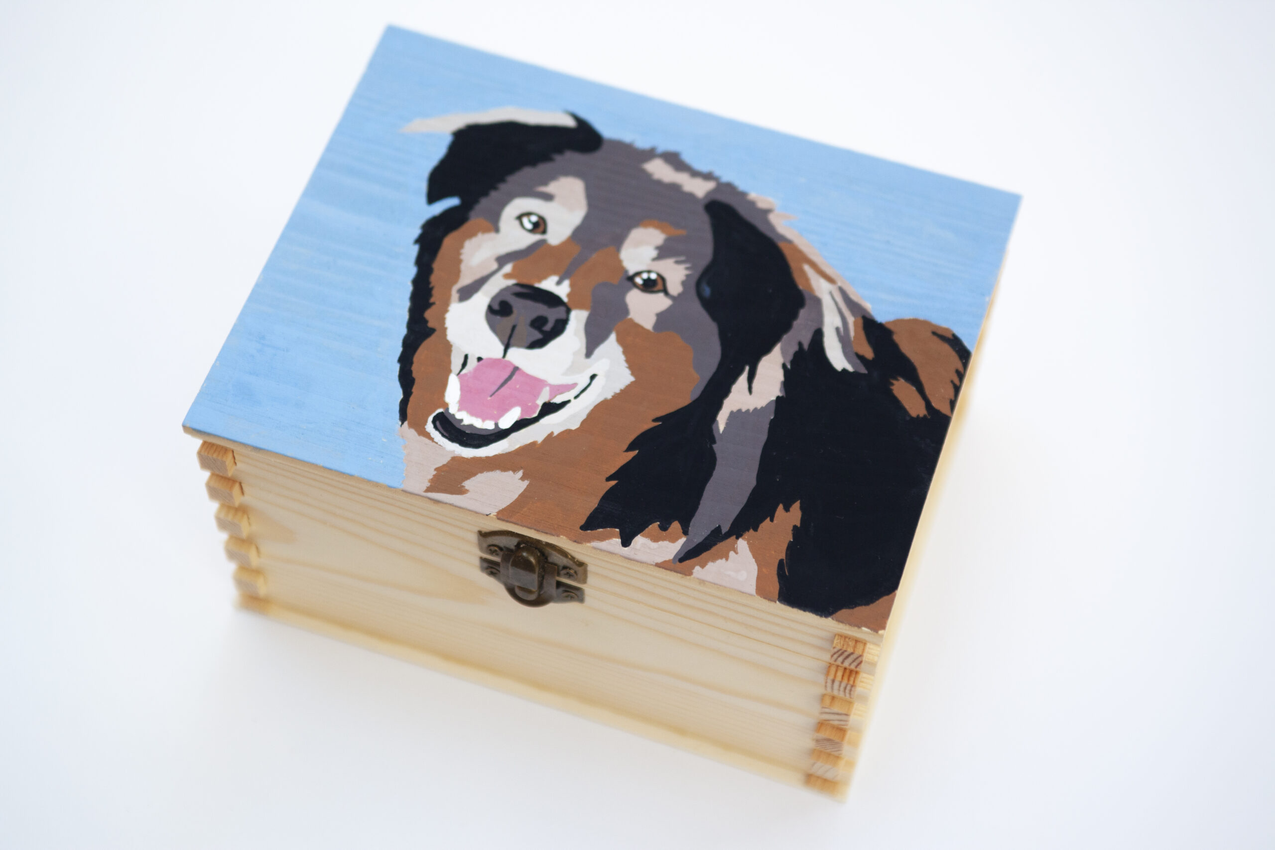 dog urn with portrait on wooden keepsake memorial box shows painting in a modern slightly abstracted style of a smiling dog